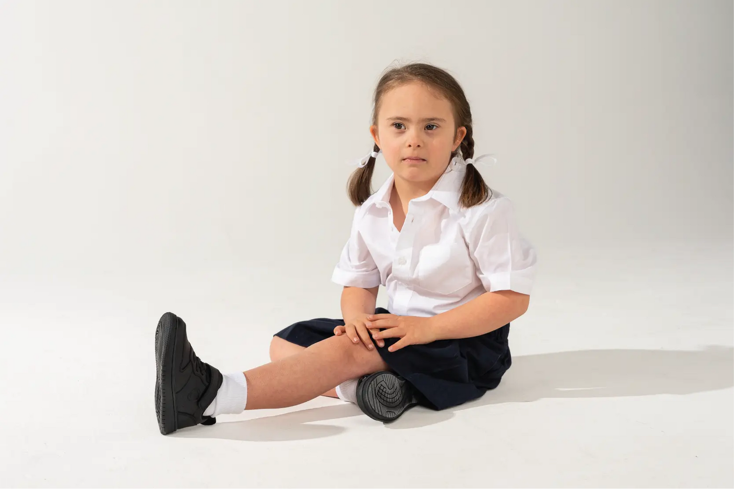 young girl sitting down
